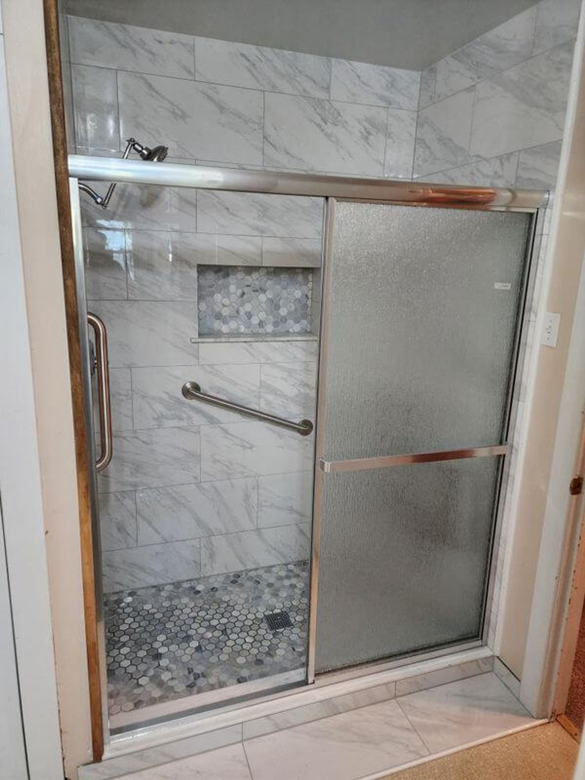 accessible shower with grab bars and shower seat