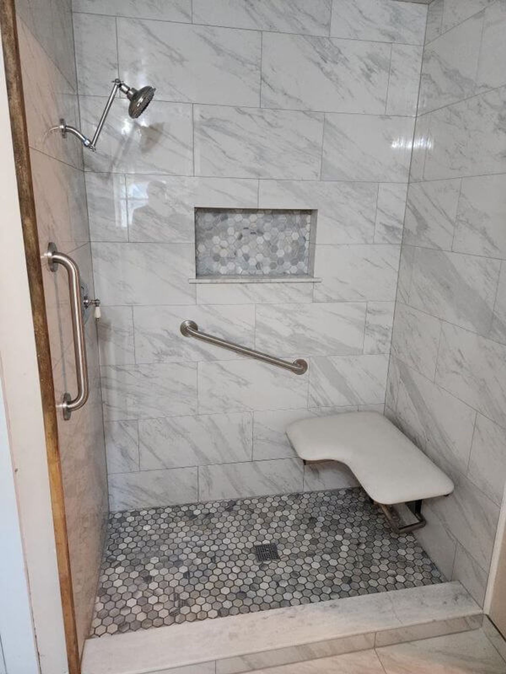 Accessible shower with grab bars and shower seat